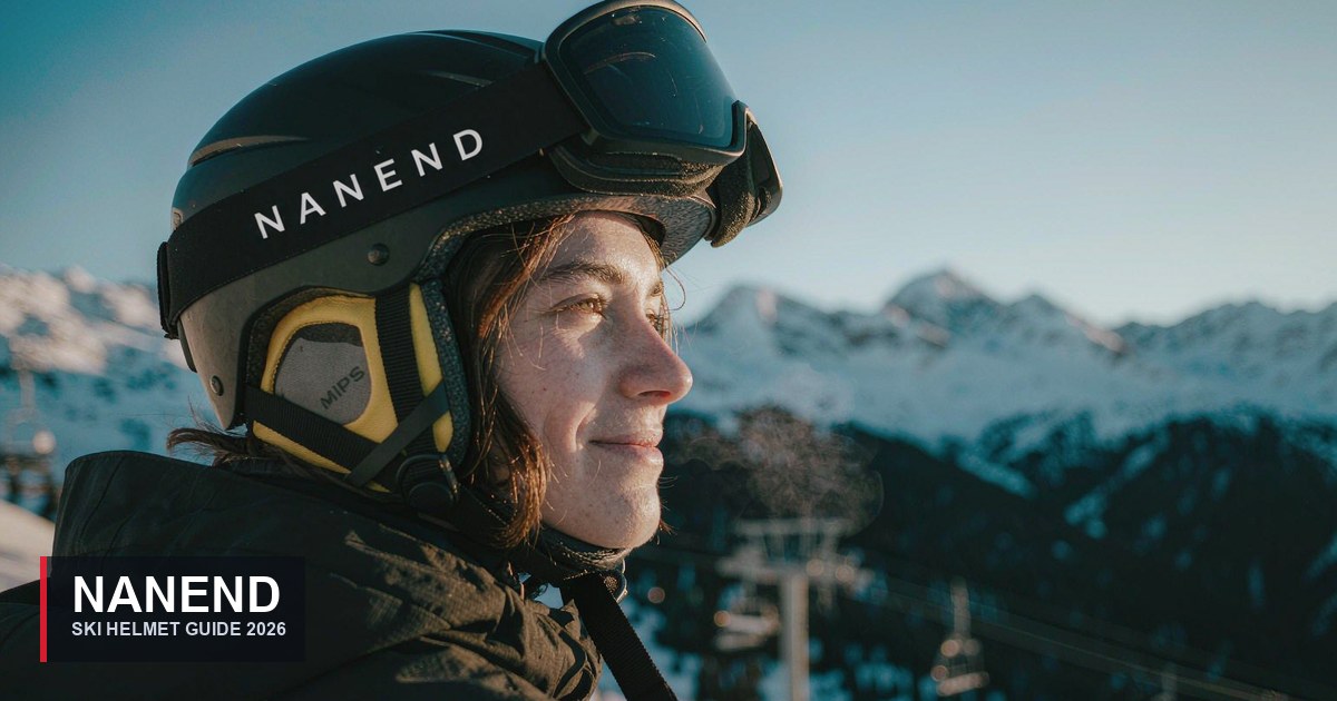 Skier wearing a black NANEND NT33 ski helmet with NANEND logo and MIPS liner, goggles pushed up, alpine background